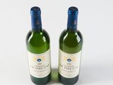 two bottles of wine sitting next to each other on a table