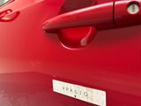 a red car with a sticker on the door handle