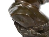 a bronze statue of a man holding a tennis racquet