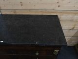 an image of a dresser in a room with wood paneling