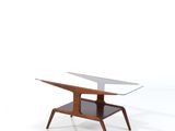une photo d'une table basse avec un plateau en verre et des pieds en bois