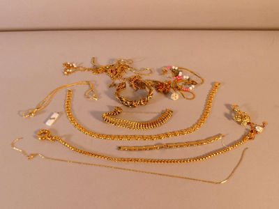 beaucoup de colliers et de bracelets en or posés sur une table
