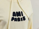an image of a yellow sweatshirt with the word am paris written on it