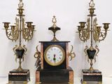 three different sized clocks sitting on a table next to each other