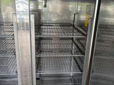 a large metal refrigerator that is inside of a building