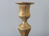 a close up of a brass candle holder on a table