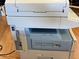 two printers stacked on top of each other on a wooden floor