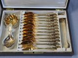 a lot of silver spoons in a box on the table