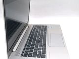 a silver laptop with a black keyboard on a white surface
