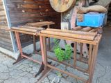 a wooden table with a plant on it in front of a building