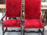 pair of red velvet upholstered chairs in an antique shop