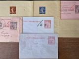 several envelopes are sitting on a table with stamps on them