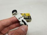 a person holding a small toy car in their hand