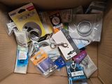a cardboard box filled with assorted electronics and other items