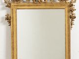 an image of a gold framed mirror on a white wall