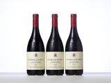 three bottles of wine sitting on top of a table