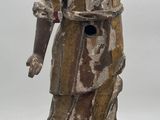 statue of a woman holding a child on a wooden base