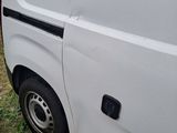 a white van that is parked on the side of the road