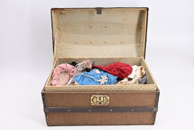 a suitcase with clothes inside of it on a white surface