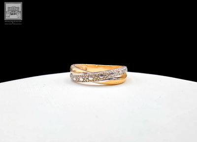an image of a gold and diamond ring on a white surface