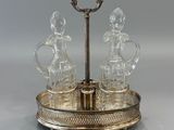 an image of a silver plate with three glass figurines on it