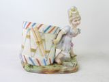 a figurine of a boy holding a kite
