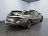 the rear end of a grey car in a large room
