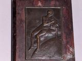 a small metal box with a picture of a man on a horse