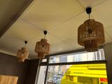a room with a lot of lights hanging from the ceiling and a yellow bus in the background