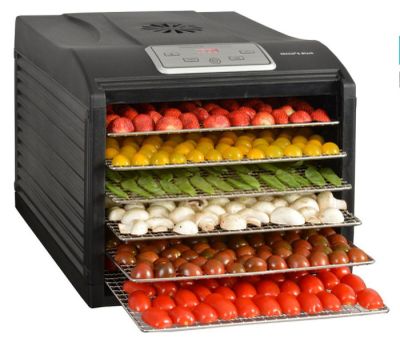 une photo d'un déshydrateur alimentaire contenant des légumes