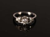 a close up of a diamond ring on a black surface