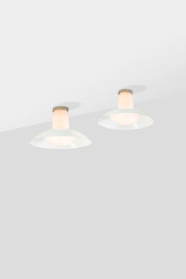two light fixtures on a ceiling with a white background