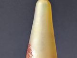 a yellow and red vase sitting on a table