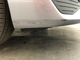 a close up of a car ' s front bumper and tire
