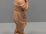 statue of a boy with a soccer ball on a pedestal