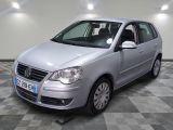 a picture of a silver car parked in a garage