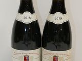 deux bouteilles de vin posées sur une table l'une à côté de l'autre