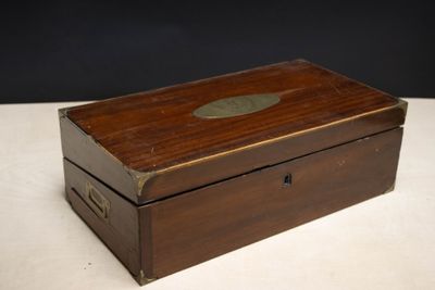 an old wooden box sitting on top of a white table