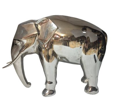 a silver elephant that is standing on a white surface