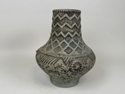 a vase that is sitting on a white surface
