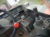a steering wheel and control panel of a tractor