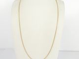 a gold chain necklace on a mannequin mannequin