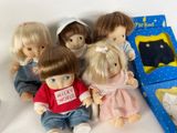 five dolls sitting next to each other on a table
