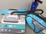 a blue bag and a black blow dryer sitting on a table