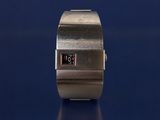 a close up of a wrist watch on a blue surface