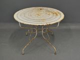 an image of a white table with a round top on a gray floor
