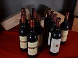 several bottles of wine are lined up on a red table cloth