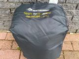 a close up of a bag on the ground near a brick wall