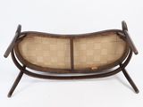 an image of a wooden bench with a woven seat on it