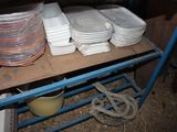 many plates and bowls sitting on a shelf in a room